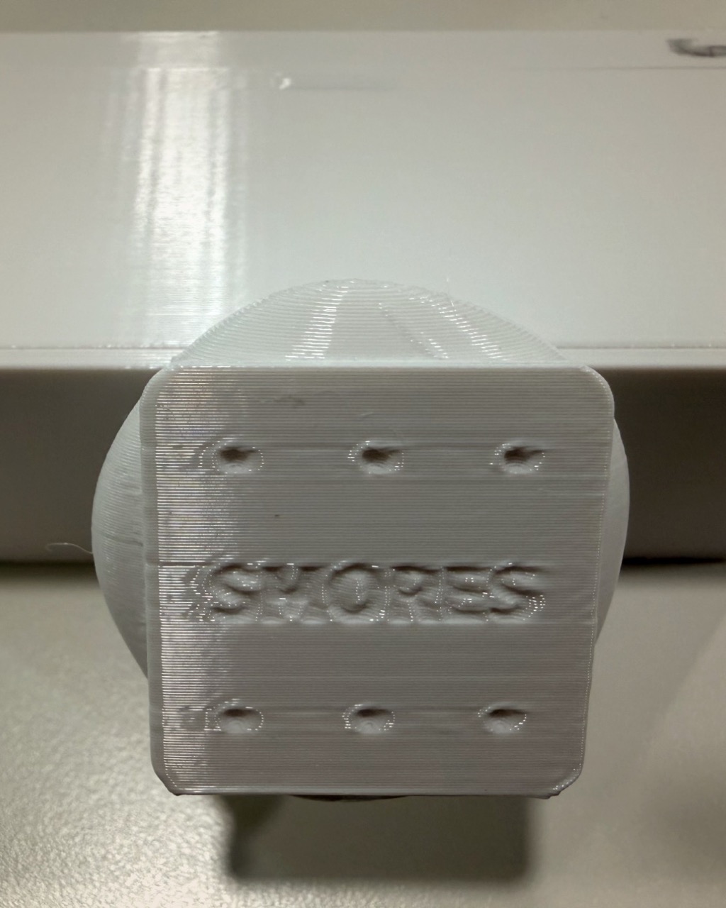Embossed Smores branding on the housing